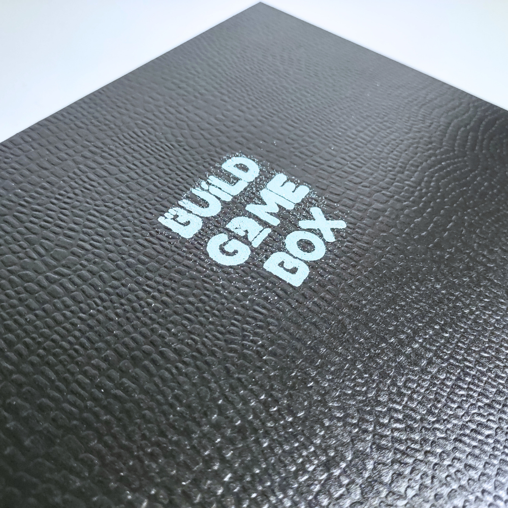 Black textured box with 'Build Game Box' text on a white background