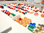 Colorful plastic gaming pieces on a white surface