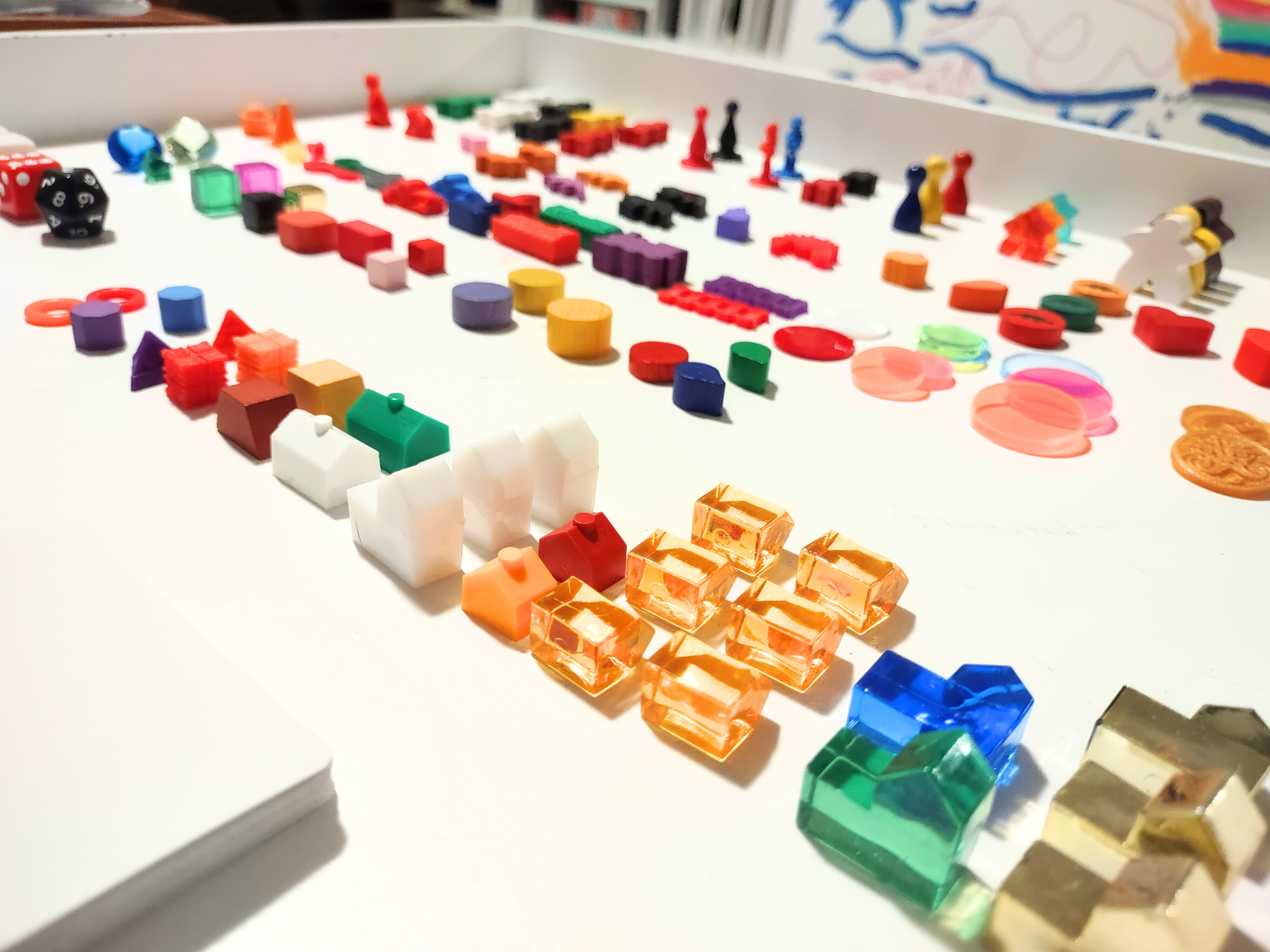 Colorful plastic gaming pieces on a white surface