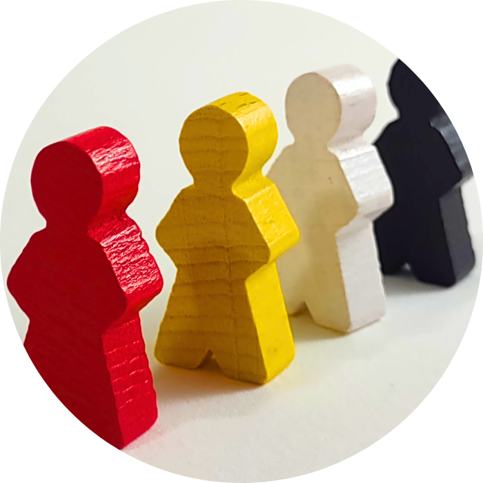 Colorful wooden meeples on a white background