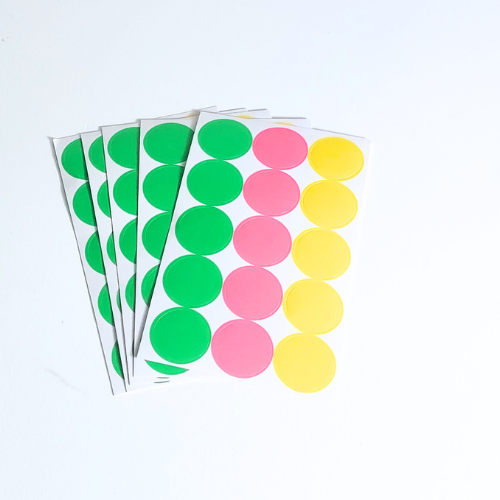 Three sheets of colorful dot stickers on a white background